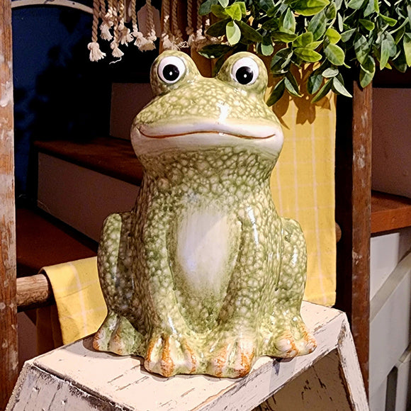 This large frog will bring a smile wherever you put it! Made of glazed terra cotta, he is a fun speckled green and is sitting, waiting for you to take him home!  Approximately 5.5