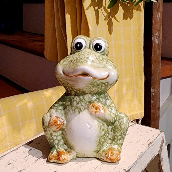 This small frog will bring a smile wherever you put it! Made of glazed terra cotta, he is a fun speckled green and is sitting, waiting for you to take him home!  Approximately 3.5