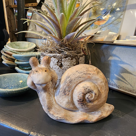 This adorable smiling snail is made of terra cotta and has been whitewashed and distressed.  Approximately 2.75