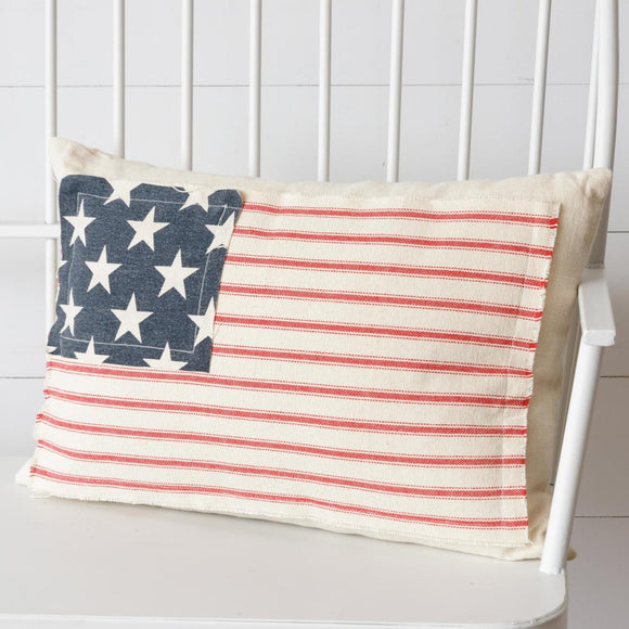 <p>What a great pillow to sit on your porch bench or living room couch! This off-white pillow has a red-ticking striped fabric sewed on the front with a square of navy fabric with stars to create the cutest American flag pillow to use year-round or for the summer holidays!</p> <p><span>13
