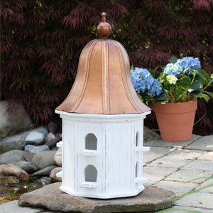 Bring the outdoors in with this beautiful white birdhouse with a tall copper roof! It has ten little purchases all around. Add a little ivy around the bottom for a great garden look in your home.  20" H x 10" Dia