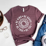 <span data-mce-fragment="1">This beautifully heathered plum tee has the words "Be kind, Be Brave, Be True, Be You" all around a sunflower in the center. It's a great t-shirt to motivate &amp; inspire! </span><span data-mce-fragment="1">Printed direct-to-fabric printing for a soft design that won't crack or peel. The shirts are soft Bella and Canvas unisex fashion-fit tees that fit like a well-loved favorite, featuring a crew neck and short sleeves.</span>