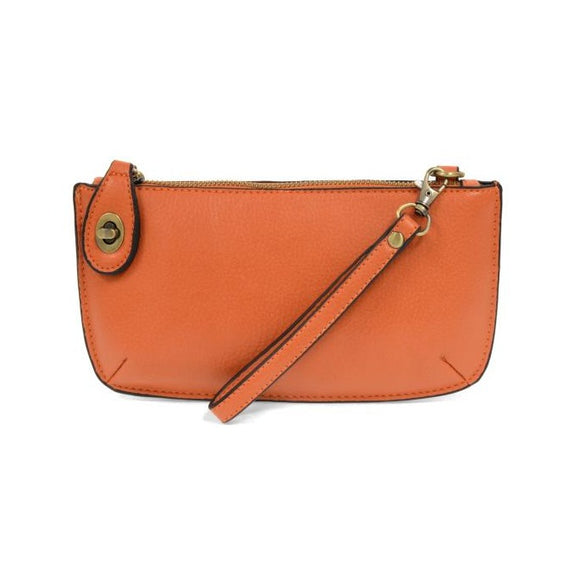 Our most popular bag, in a beautiful mango color, this mini clutch, with its sleek silhouette, is as gorgeous as it is versatile.  Features include a polished turn lock, six card slots, and an interior zipper for change.  It can be styled in many ways, with removable straps for alternating between wallet, crossbody, and wristlet!   5