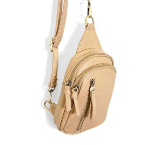 Blending uptown chic with downtown cool, the Skyler sling bag is made in beautiful vegan camel-colored leather! A convertible strap lends versatility, while a front zip pocket offers practical storage for your necessities. It is the perfect companion for a night out on the town or a fun day trip!   8