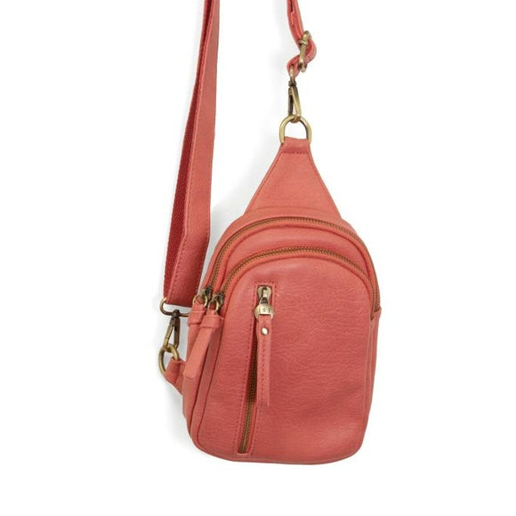 Blending uptown chic with downtown cool, the Skyler sling bag is made in rich vegan coral leather! A convertible strap lends versatility, while a front zip pocket offers practical storage for your necessities. It is the perfect companion for a night out on the town or a fun day trip!  8