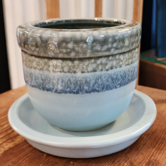This pretty blue stoneware pot comes with a matching saucer and has a drain hole at the bottom of the pot. Stick one of your favorite plants (or artificial) in it and put it in a spot where you'll see it ~ it will surely make you smile!   3 1/2