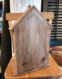 This birdhouse will look cute anywhere you put it inside or outside of your home!  There is a large birdhouse with a smaller one in front of it.  Both fronts have a distressed white splattered finish on the galvanized metal.  There is a rope attached to the black hook on the top of the largest birdhouse to easily hang it if you wish! 6.75" W x 5"D x 10.5" H (including hook)