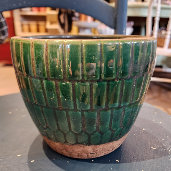 You'll love this beautiful green tiled distressed terracotta pot! Whether you put a live plant or an artificial one in it, it will accent your room perfectly! (It easily fits a three to four-inch potted plant) It has three pad protectors on the planter's base to protect the surface you place it on. Approximately 5.75