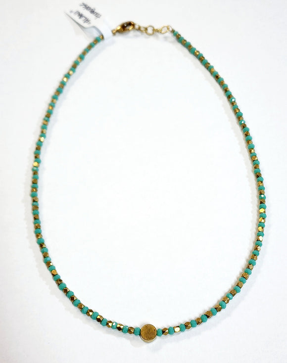 This choker is so pretty and will look great layered or worn alone!  Brass and multi-colored grey faceted beads alternate and meet in the center will a circular brass bead for a fun detail!  There is a lobster clasp closure with room to adjust the size of the necklace from 14.5