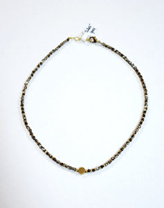 This choker is so pretty and will look great layered or worn alone!  Brass and multi-colored grey faceted beads alternate and meet in the center will a circular brass bead for a fun detail!  There is a lobster clasp closure with room to adjust the size of the necklace from 14.5" - 15"  Handmade by a young designer and team of artists in Northern India