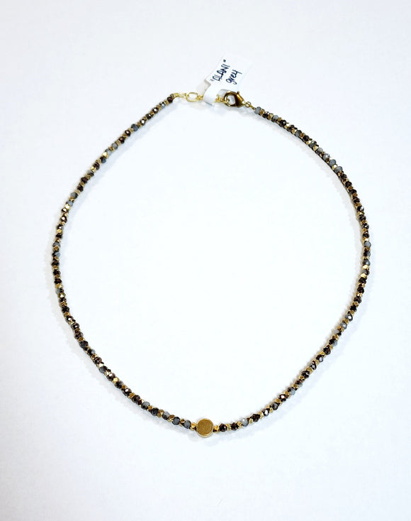 This choker is so pretty and will look great layered or worn alone!  Brass and multi-colored grey faceted beads alternate and meet in the center will a circular brass bead for a fun detail!  There is a lobster clasp closure with room to adjust the size of the necklace from 14.5