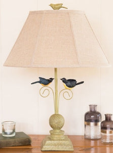 Two painted birds perch, ready to fly, under a shade, topped with a bird finial. This 24" table green lamp is perfect for bird lovers or anywhere you want a touch of the outdoors brought inside. It comes with a beautiful linen shade.  Dimensions 12" l x 18" w x 24" h  Weight 7 lb  Available for pick-up only at this time