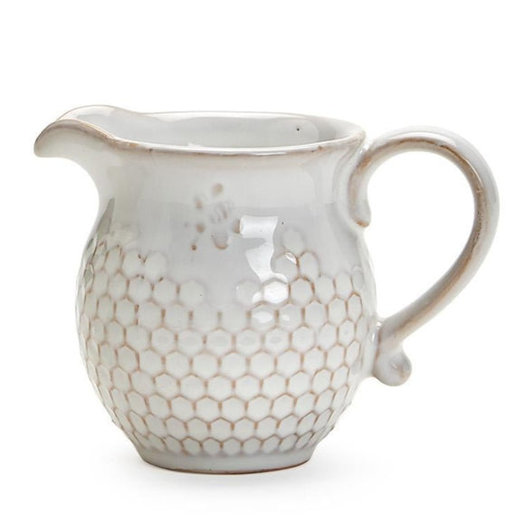 This little pitcher is ever so sweet!  It is hand glazed with a soft, translucent glaze showing off the beautiful stoneware and the bee stamped above the pretty honeycomb design all around the creamer. It is dishwasher-safe.   Stoneware    5