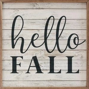 On a shiplap whitewashed background are the words "hello fall" in a black mixed font - a great piece to add to your fall decor!