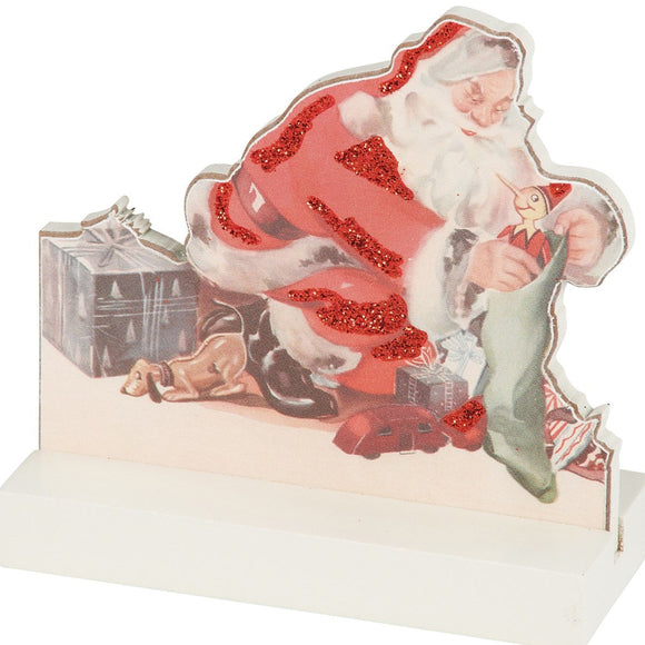 This vintage-inspired wooden Santa is busy filling a stocking on Christmas Eve! This board looks cute mixed in with your other Christmas decor or standing alone!