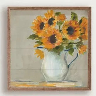 We are in love with our newest sunflower print by Sue Schlabach! A white pitcher with blue trim sits on a table off to the right, with beautiful yellow sunflowers coming out of the top.   It is made from high-quality American hardwood planks with a hand-painted face, printed with UV-cured ink, and framed in a natural walnut frame. Each piece is unique with its own personality, marks, wood grain, and look. Easy to clean with a dry cloth.  Made in the USA.  8