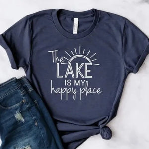 Our "The Lake Is My Happy Place" t-shirt will tell it all...YOU are a LAKE person! It is beautiful heathered navy color with "The Lake Is My Happy Place" written in a white mixed font with sunrays above.   These T-shirts are so soft & comfy that you will love wearing them everywhere. The styling possibilities are endless. Roll up the sleeves, tie a side knot, front tuck, or wear it while lounging around the house. 