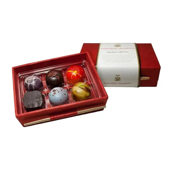 Fritz Knipschildt’s assortment of chocolates is packaged in handcrafted red boxes using all-natural paper from Nepal and sealed with a bamboo stick. These chocolates use the finest ingredients to create decadent flavor pairings of rich chocolate with spices, herbs, nuts, and fruits. Shelf Life: 8 months Net Wt: 2.1oz