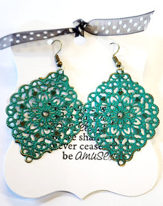We love these earrings because they can make a statement but feel oh-so lightweight on your ears! This beautiful fillagree floral earring will take you from day to night in a snap!  2 2/3" drop. Hand-painted in "Teal". Nickle and Lead Free.