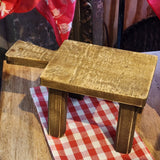 This distressed wooden stool is perfect for setting a plant, small lamp, or cute vignette on!  If you need to give something some height to your decor, this little stool will help you do just that!  Rectangle top.  4.5" H x 9.5" L, 4.75"D