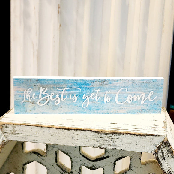 This mini sign has a turquoise blue washed wooden background with the words 
