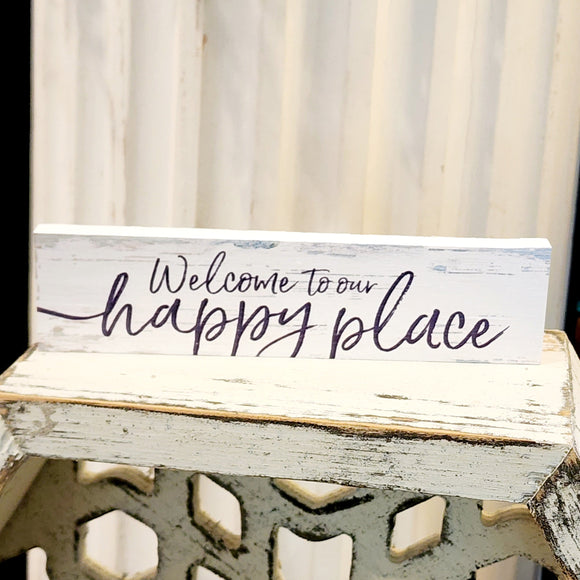 This mini sign has a whitewashed wooden background with hints of greys and turquoise. The words 