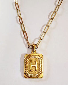These initial necklaces are one of the hottest looks for this season!  Gold-plated rectangle initial charm with the letter "H" on it comes on a paper clip chain that is 18" long with a 2" extender and a lobster clasp closure.  Made in the USA.