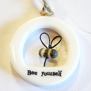 This little circular porcelain gift tag is sure to bring a little happiness to you or someone you give it to!  Inside the cut-out is a bumblebee; below it is the word "Bee Yourself." A jute rope is attached at the top for hanging.  1 1/4" Dia