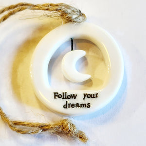 This little circular porcelain gift tag is sure to bring a little happiness to you or someone you give it to!  Inside the cut-out is a moon; below it is the word "Follow Your Dreams."  A jute rope is attached at the top for hanging.  1 1/4" Dia