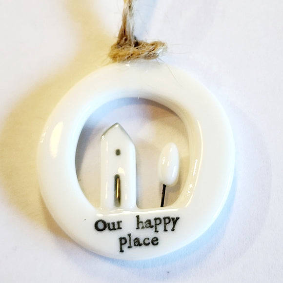 This little circular porcelain gift tag is sure to bring a little happiness to you or someone you give it to!  Inside the cut-out is a house and tree; below it is the word 