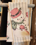 Let it SNOW!  At least on your dishtowel!  We are smitten with our snowman dishtowels! The first one has red ticking stripes on a linen color background with the sweetest retro snowman with a candy cane in one hand while waving to you with the other!  The second dishtowel is the same linen-colored background with the same snowman scattered on it!  Put something happy in your kitchen this Christmas (or give it!!)