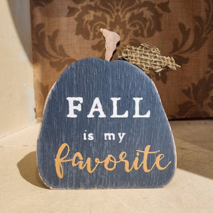 So fun to mix in with your other fall decor, this black wooden pumpkin has the words "fall is my favorite" in a mixed font on the front of the pumpkin.   4.25" H x 2.75" W x .75" D