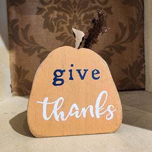 So fun to mix in with your other fall decor, this orange wooden pumpkin has the words "give thanks" in a mixed font on the front of the pumpkin.   3" H x 2.5" W x .75" D