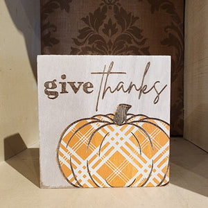 This weathered white wooden block has the cutest orange plaid pumpkin on it with the words "Give Thanks" above. It is freestanding so you can use it anywhere in your fall decor this year!   4″W x 4″H x 1.3″D