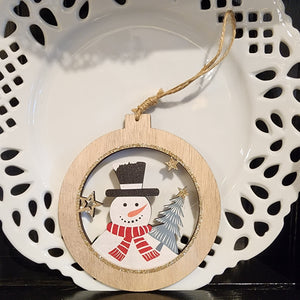 This cute little snowman ornament greets you out of a wooden cutout ornament.  Included a twine rope to hand if you'd like!  5"H x 4.75"W 