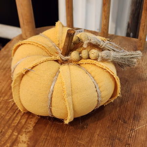 This light orange fabric pumpkin is adorable and ready to put a bright spot in your fall decor this year! It has twine accents and a beaded twine bowl around the wooden stem.  4" Dia  Polyester, Wood