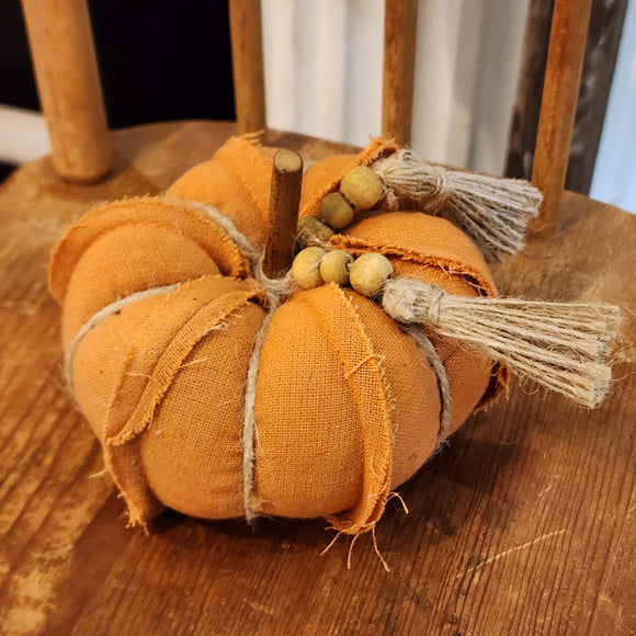 This dark orange fabric pumpkin is adorable and ready to put a bright spot in your fall decor this year! It has twine accents and a beaded twine bowl around the wooden stem.  4