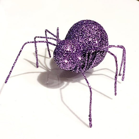 You'll love this little black glittered spider with tin legs, it is easy to set out anywhere in the house! It will add a spooky touch to your Halloween decor this year.  Purple glittered wire.  Approximately 2