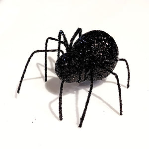 You'll love this little black glittered spider with tin legs is easy to set out anywhere in the house! It will add a special touch to your Halloween decor this year.  Glittered Wire.  Approximately 2" X 3" X 1.25"