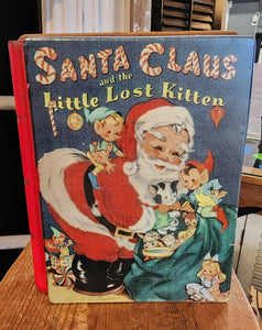 You'll love decorating with this vintage-inspired metal book box this year! With a cover of "Santa Claus and the Little Lost Kitten" with Santa opening his back of toys and holding a kitten as his elves look on, you'll bring a touch of days gone by with this metal book that you can even store things in!  9" H x 7" W x 2" D