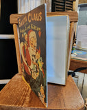 You'll love decorating with this vintage-inspired metal book box this year! With a cover of "Santa Claus and the Little Lost Kitten" with Santa opening his back of toys and holding a kitten as his elves look on, you'll bring a touch of days gone by with this metal book that you can even store things in!  9" H x 7" W x 2" D