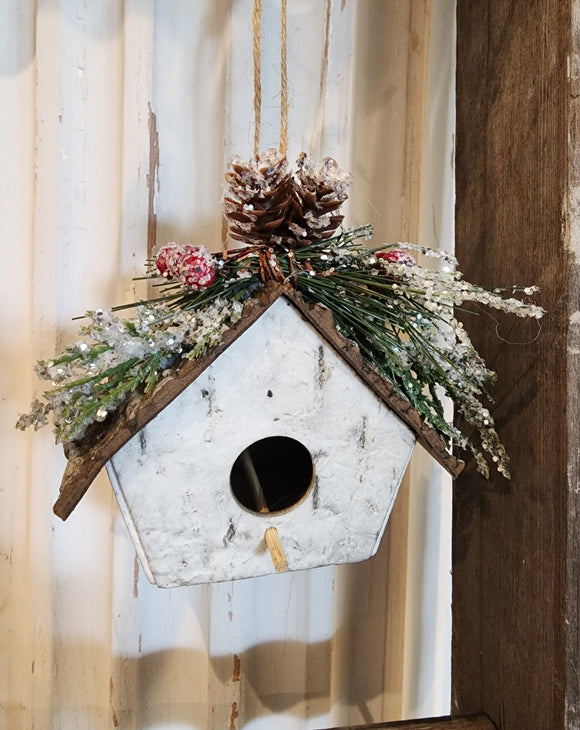The perfect ornament for your favorite bird lover!  This birch birdhouse has evergreen and berries decorating the top and comes with a twine string to hang.  3.25