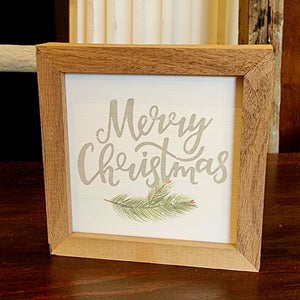 We love this distressed whitewashed background with "Merry Christmas" written on it in a pretty green color with a sprig of evergreen below.  It is made from high-quality American hardwood planks with a hand-painted face, printed with UV-cured ink, and framed in a natural walnut frame. Each piece is unique with its own personality, marks, wood grain, and look. Easy to clean with a dry cloth.  Made in the USA  4" x 4" x 1"