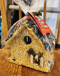 This adorable cottage is a sweet seed treat for your birds this winter. Hand decorated with red raffia, juniper, cranberries, and millet. Under the seed and decoration is a small ornamental wooden birdhouse. Absolutely the perfect gift for teachers, neighbors, friends, and family. Packaging information: clear polybag closed with artificial pine bough or red raffia.  Made in the United States   Dimensions: 6″ x 6″ x 7″