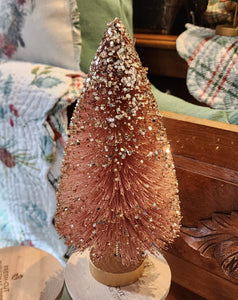This beautiful rose quartz tree has gold glitter cascading from its top and is perfect for accenting any space in your home.   Materials: Glittered bottle brush.  Dimensions:  9" X 4.5" X 4.5"