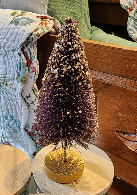 This beautiful amethyst tree has gold glitter cascading from its top and is perfect for accenting any space in your home.   Materials: Glittered bottle brush.  Dimensions: 7