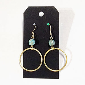 These stylish earrings have a turquoise bead hanging above the brushed gold circle  Approximately 2.75" in length. 