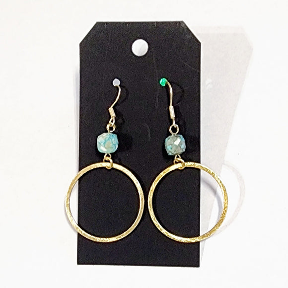 These stylish earrings have a turquoise bead hanging above the brushed gold circle  Approximately 2.75