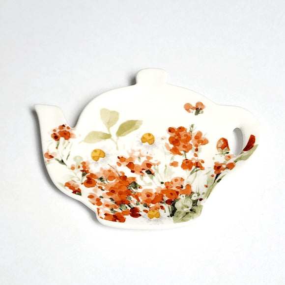 This adorable teapot shape tea bag holder has a pretty wildflower design featuring poppies in a delicate watercolor style on a white background.  Microwave, dishwasher, and food-safe for convenient use.  Stoneware  4.5