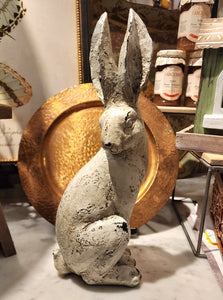 We are loving our new distressed rabbit! He will look great mixed in with your decor. Pair him with our other distressed rabbit that is a little smaller and has her ears back. This distressed rabbit is sitting up and looking behind his left shoulder and his ears are pointed straight up. His finish has a distressed grey wash over a cream base color.  12.25" H x 4.5  x" W x 3.5" D Polyresin, Stone Powder